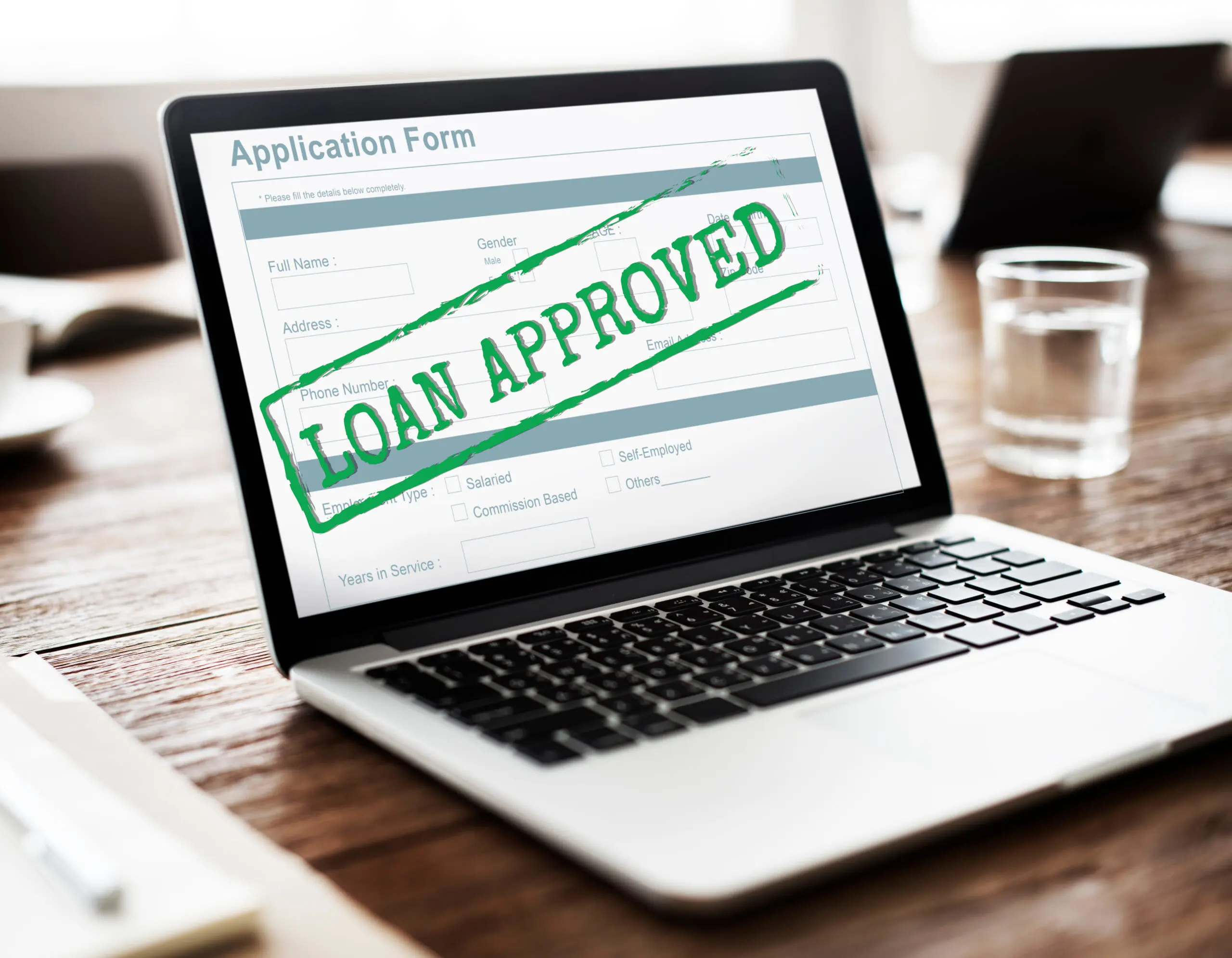 Loan Approved Accepted Application Form Concept Laptop displaying an application form stamped ‘Loan Approved’, symbolizing contingency fee financing approval for plaintiff law firms.