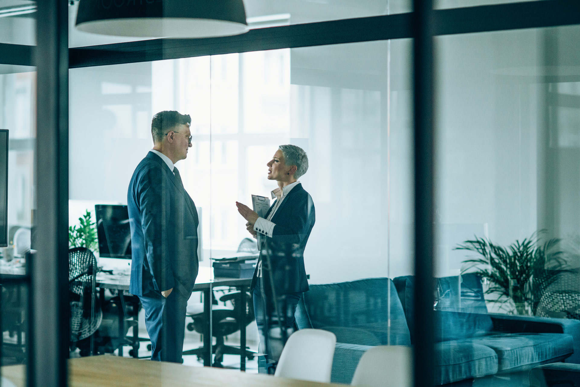 business-people-chatting-in-the-office-sz Two lawyers chatting in an office setting